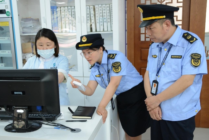 圖為6月19日執(zhí)法人員在一家藥品零售企業(yè)門店檢查含特殊藥品復方制劑的“進銷存”情況和購買此類藥品顧客的人員信息登記情況。